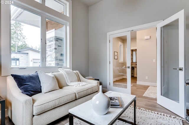 living room featuring french doors and light wood-type flooring