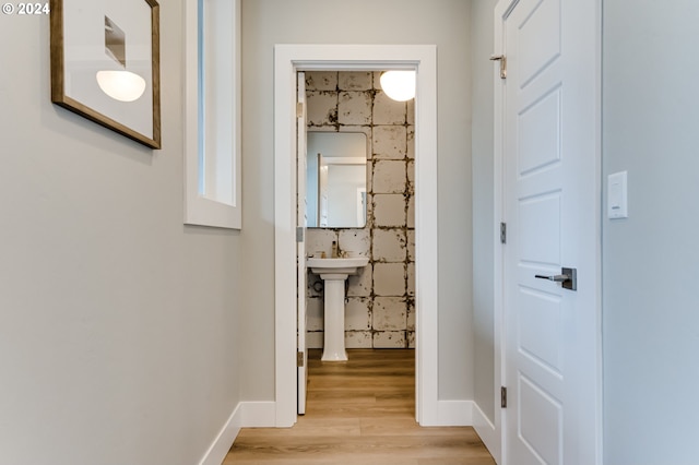 corridor featuring light hardwood / wood-style floors and sink