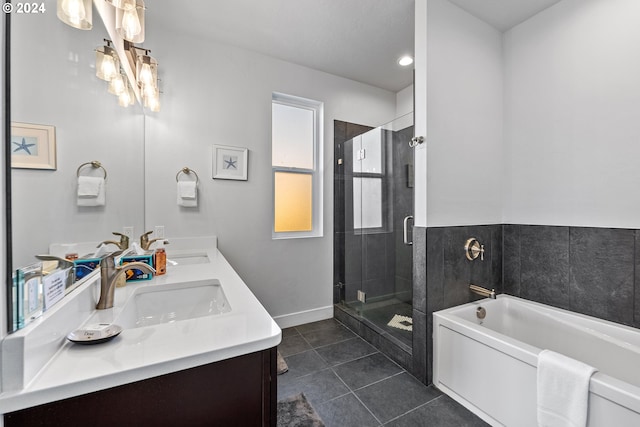 bathroom featuring tile flooring, independent shower and bath, and double vanity