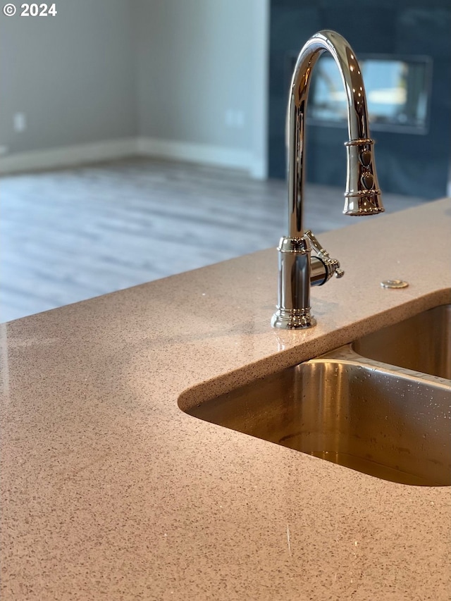 details featuring hardwood / wood-style flooring and sink