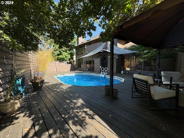 view of swimming pool with a wooden deck