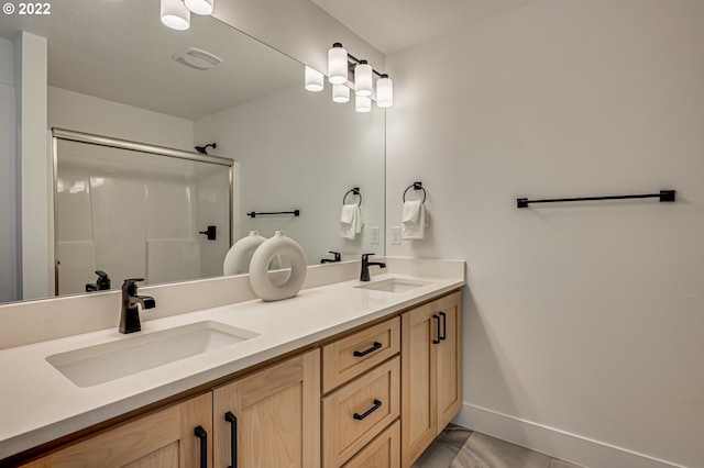 bathroom with walk in shower, tile patterned flooring, and vanity