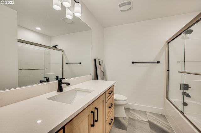 full bathroom with shower / bath combination with glass door, vanity, toilet, and tile patterned floors