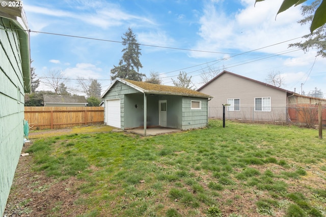 rear view of house with an outbuilding, a garage, and a lawn