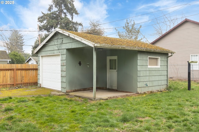 back of house with a garage and a yard