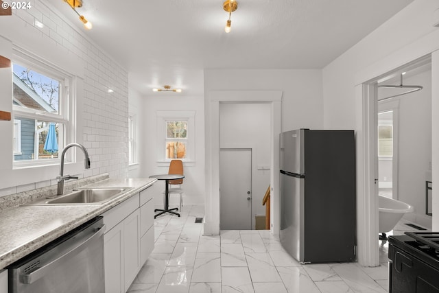 kitchen featuring white cabinetry, sink, and appliances with stainless steel finishes