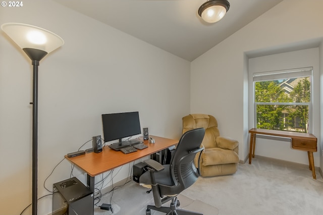 carpeted office space featuring vaulted ceiling