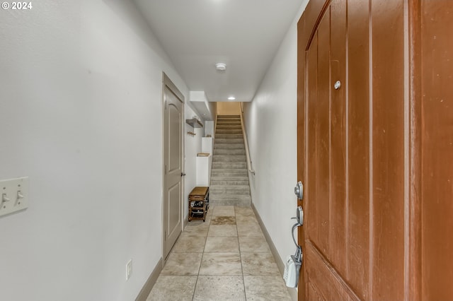 hall featuring light tile patterned floors