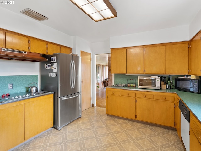 kitchen with dishwasher, stainless steel fridge, and decorative backsplash