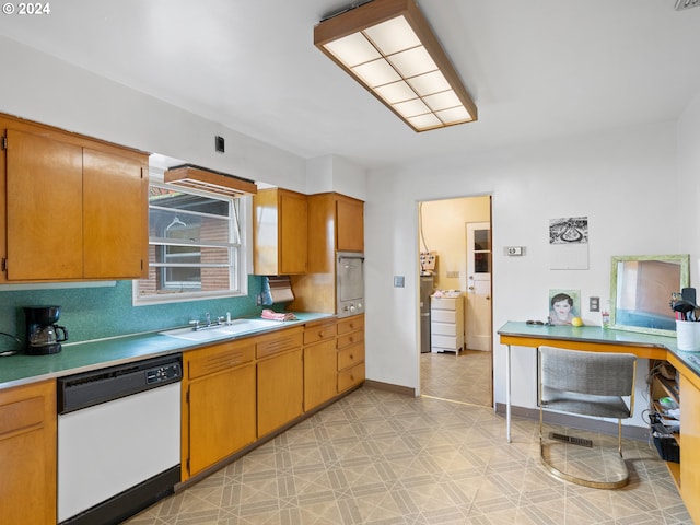 kitchen featuring dishwasher, tasteful backsplash, and sink