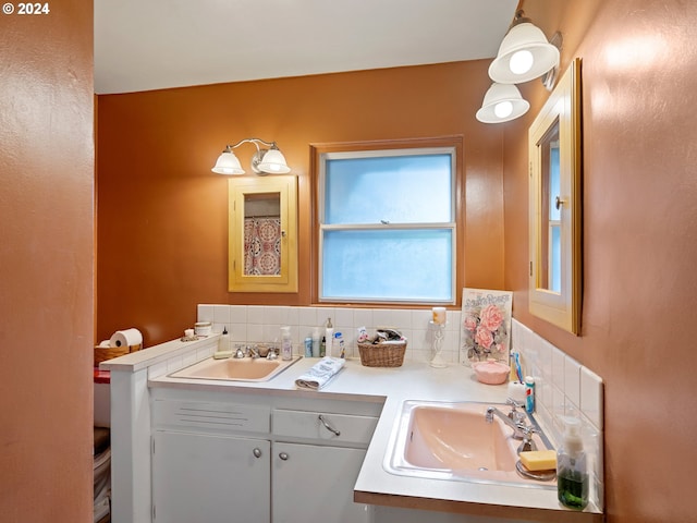 bathroom featuring vanity and backsplash