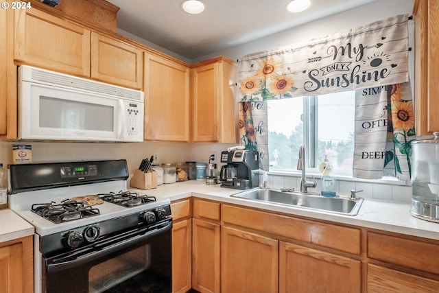 kitchen featuring white appliances and sink