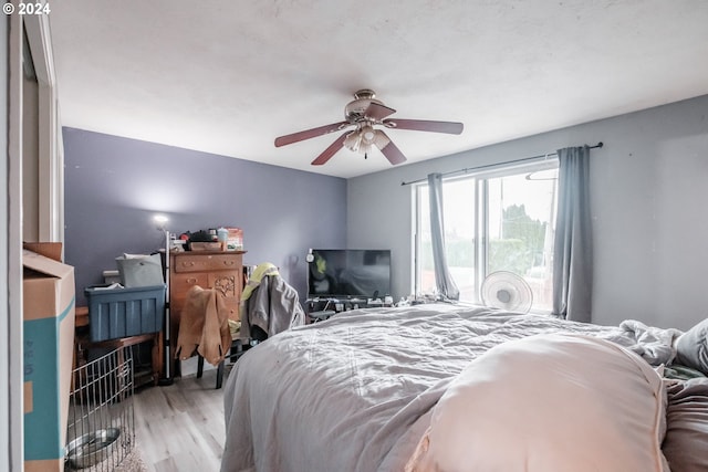 bedroom with ceiling fan and light hardwood / wood-style flooring