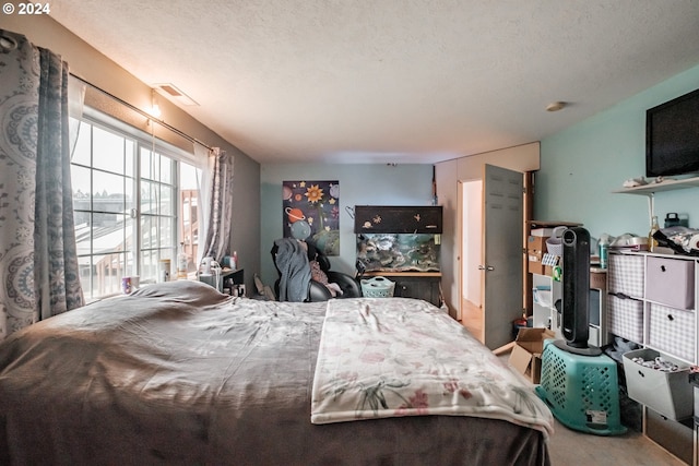 bedroom featuring carpet and a textured ceiling