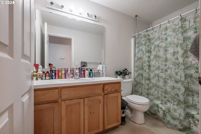 bathroom featuring curtained shower, vanity, and toilet