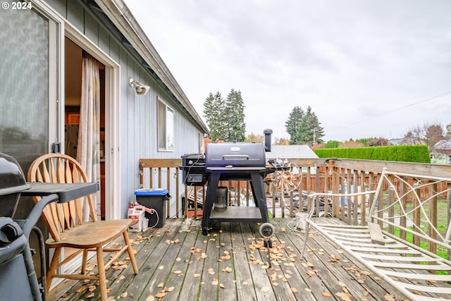 wooden deck with a grill