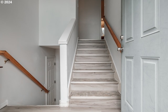 stairway featuring wood-type flooring