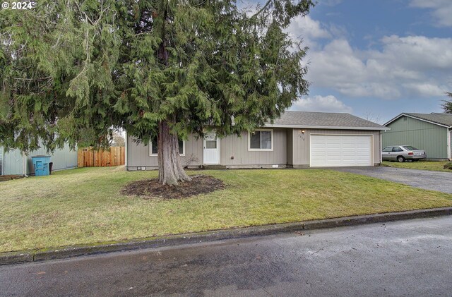 view of front of house featuring a garage and a front lawn