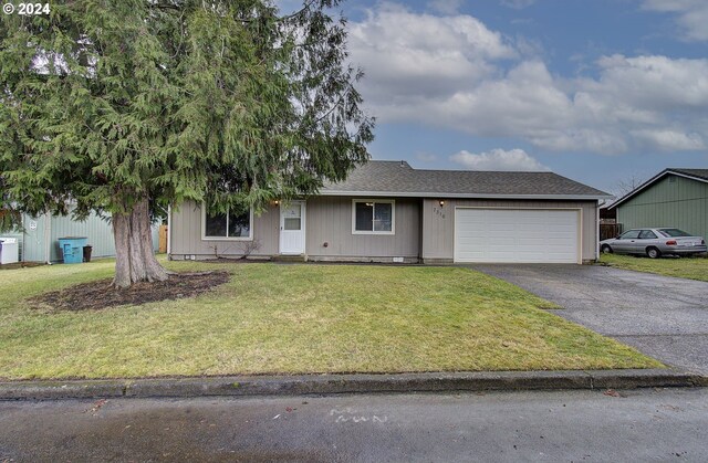 ranch-style home with a garage and a front yard