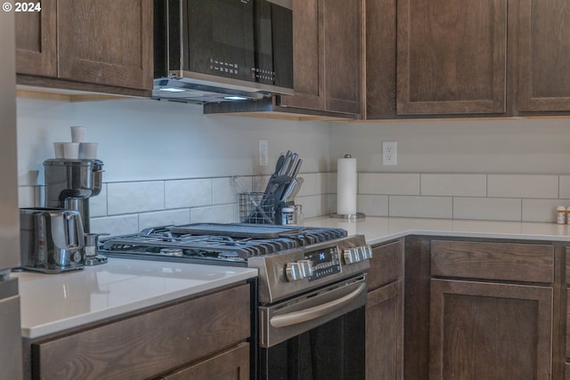 kitchen featuring stainless steel appliances, light countertops, decorative backsplash, and dark brown cabinets