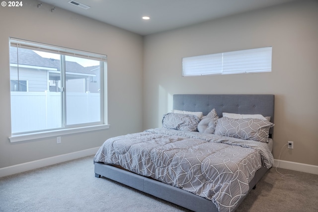 carpeted bedroom featuring recessed lighting, visible vents, and baseboards