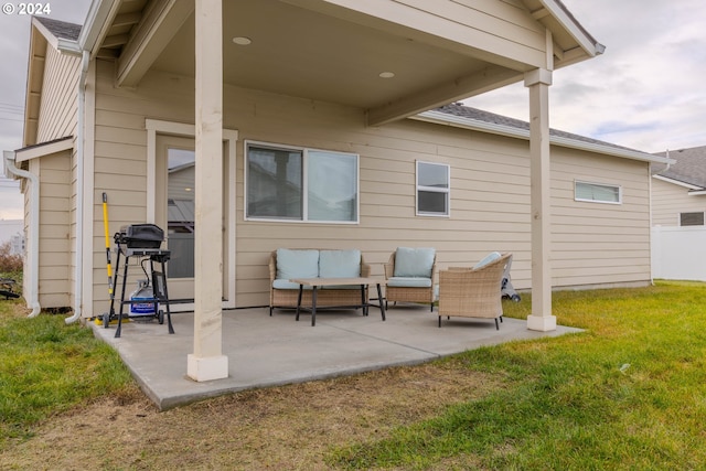 rear view of property featuring a yard, outdoor lounge area, and a patio