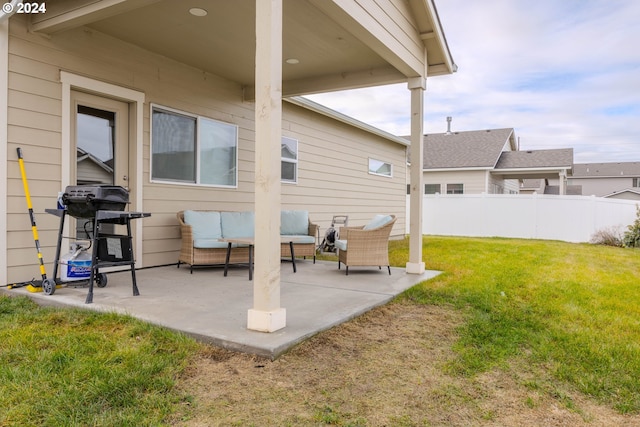 view of patio / terrace featuring a grill, fence, and an outdoor living space