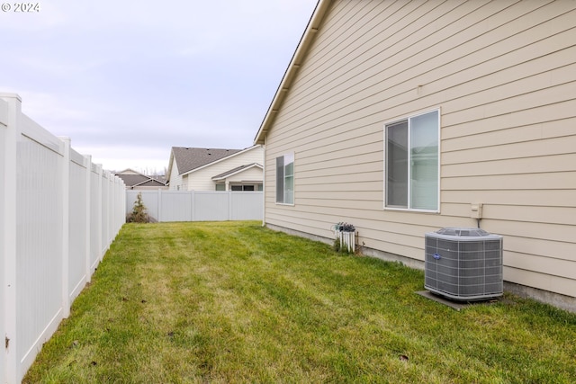 view of yard featuring central AC unit and a fenced backyard