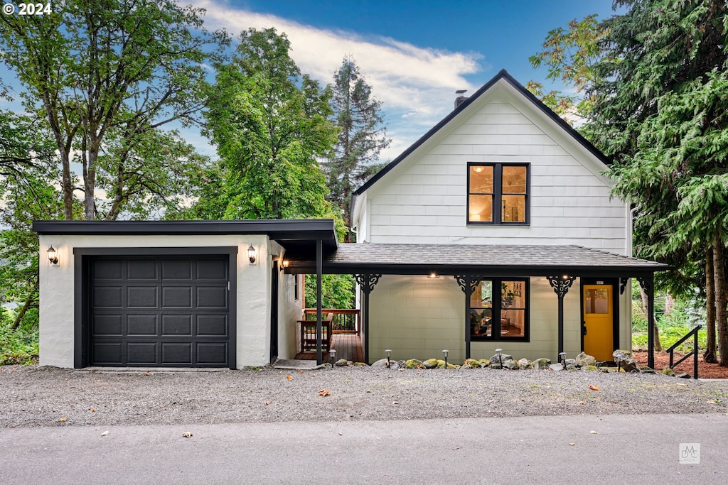 view of front of home featuring a garage and a porch