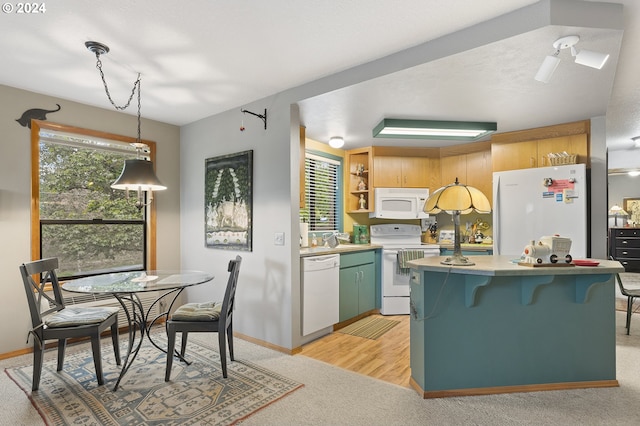 kitchen with a textured ceiling, light hardwood / wood-style floors, decorative light fixtures, and white appliances