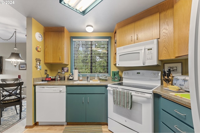 kitchen with sink, light hardwood / wood-style floors, decorative light fixtures, and white appliances