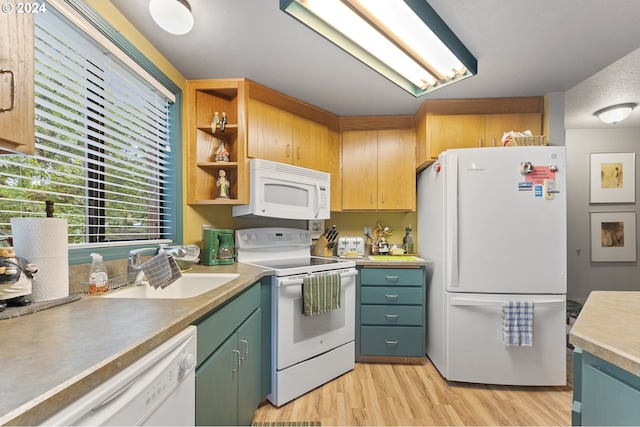 kitchen featuring sink, a textured ceiling, light wood-type flooring, and white appliances