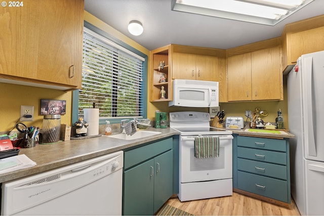 kitchen with white appliances, light hardwood / wood-style flooring, and sink