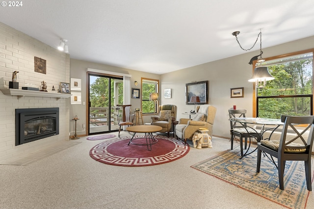 living room with carpet floors and a brick fireplace