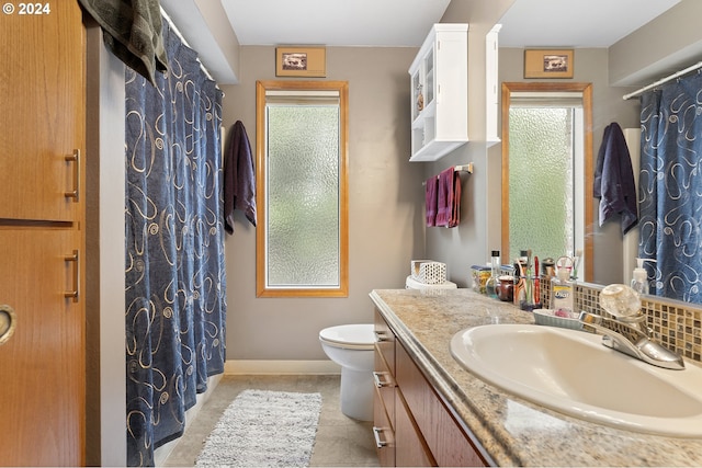 bathroom with vanity, toilet, tile patterned floors, and a shower with curtain