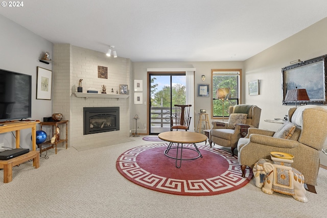 living room with carpet flooring and a fireplace