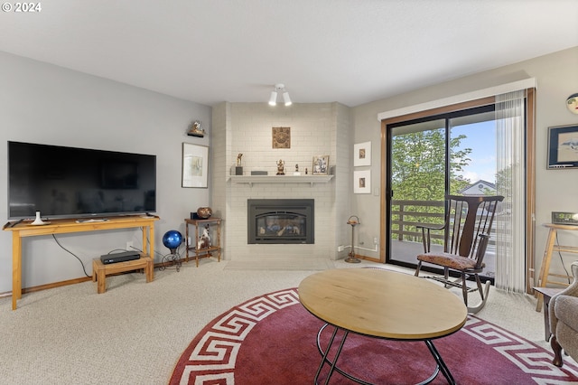 carpeted living room featuring a brick fireplace