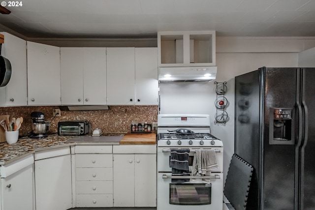 kitchen featuring gas range oven, black refrigerator with ice dispenser, decorative backsplash, white cabinetry, and wall chimney exhaust hood