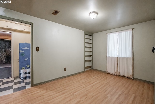 spare room with wood-type flooring