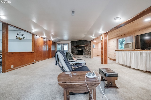 living room with wood walls, a healthy amount of sunlight, and light colored carpet