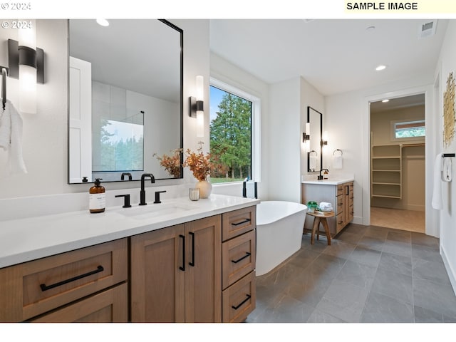 bathroom with vanity and a bathtub