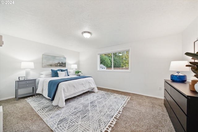 carpeted bedroom featuring a textured ceiling