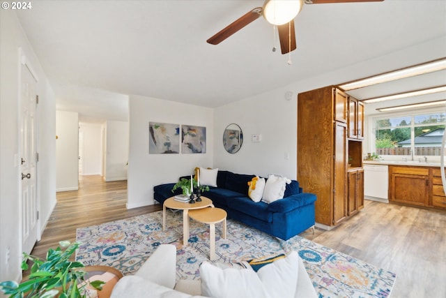 living room featuring light hardwood / wood-style floors and ceiling fan