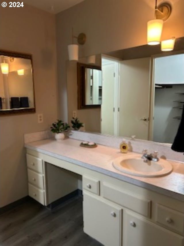 bathroom with hardwood / wood-style floors and vanity