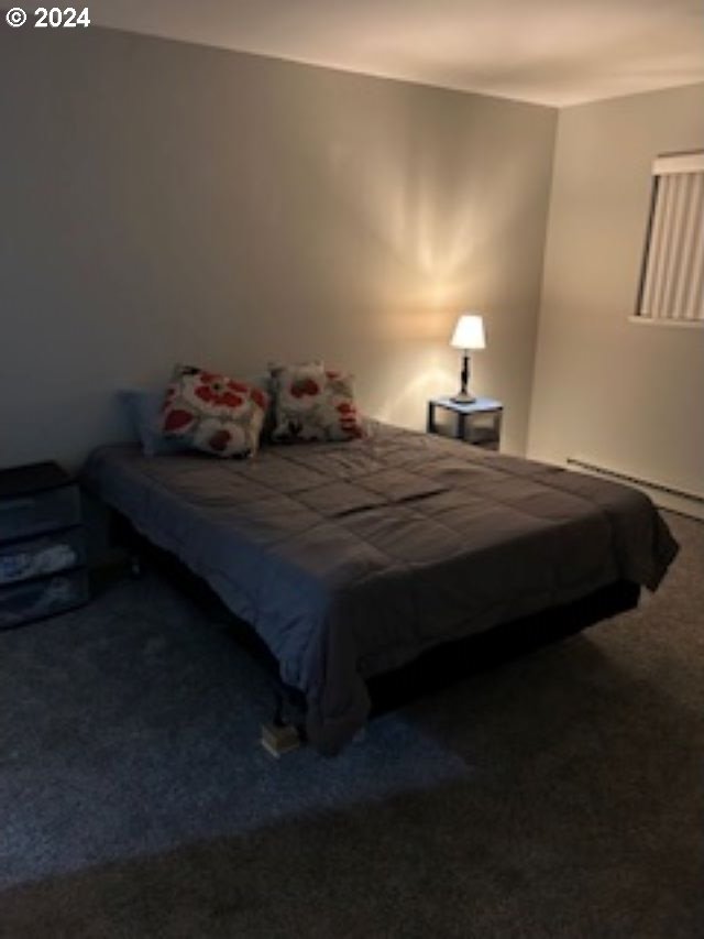 carpeted bedroom featuring a baseboard radiator