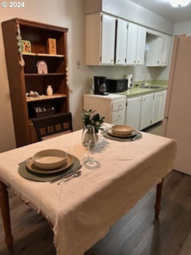 dining space featuring dark hardwood / wood-style flooring and sink