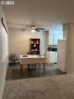 dining area with ceiling fan and dark hardwood / wood-style floors