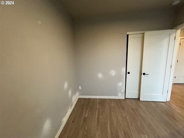 unfurnished bedroom featuring hardwood / wood-style flooring