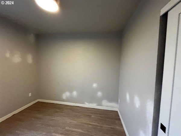 spare room featuring dark hardwood / wood-style flooring