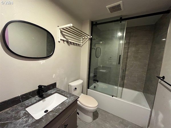 full bathroom featuring vanity, toilet, and bath / shower combo with glass door